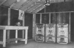 A view inside an Army kitchen shack. Three M1937 gasoline-fired field ranges are positioned on the back wall.