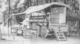An Army kitchen truck set up to serve a meal in the forward area.